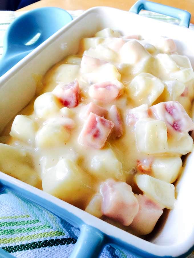 ham and potato in cheese sauce in a casserole dish for baking