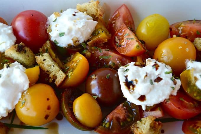 Take advantage of the season, make this Fresh Tomato and Burrata Salad recipe! The tomatoes are sweet and juicy, the fresh burrata mozzarella is creamy and delicious with the added salted crouton for that perfect crunch to hit on all of your food cravings!