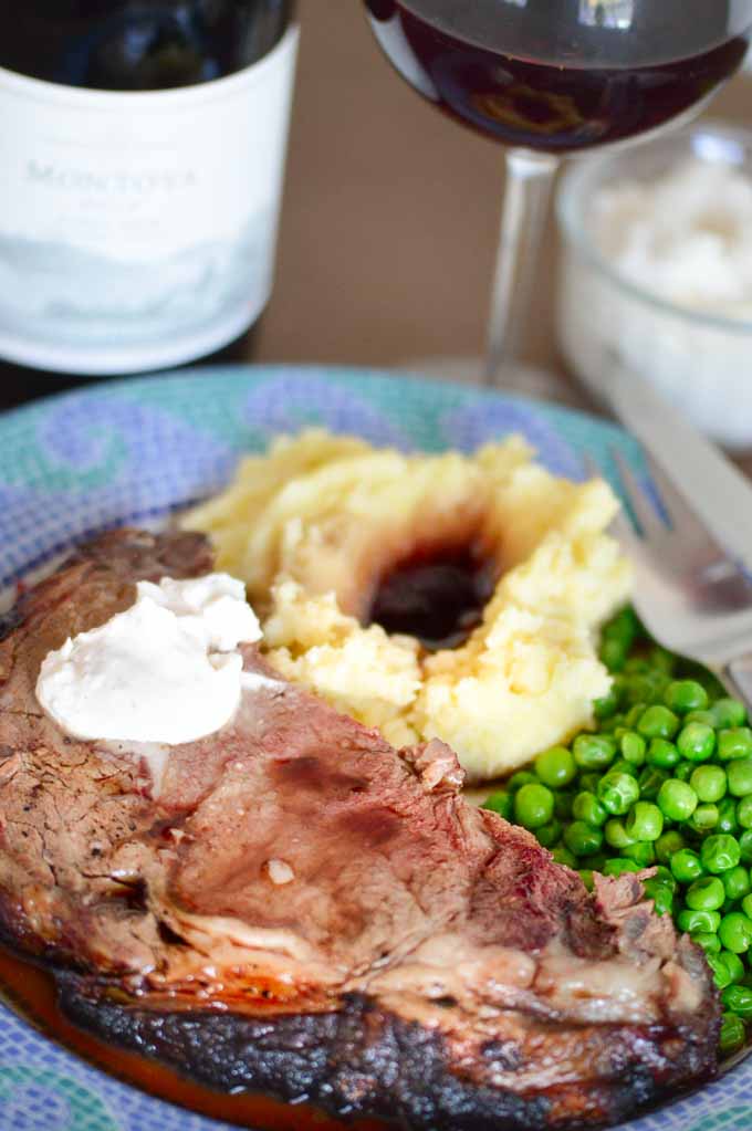 Holiday Dinner of prime rib, mashed potatoes and peas on a plate