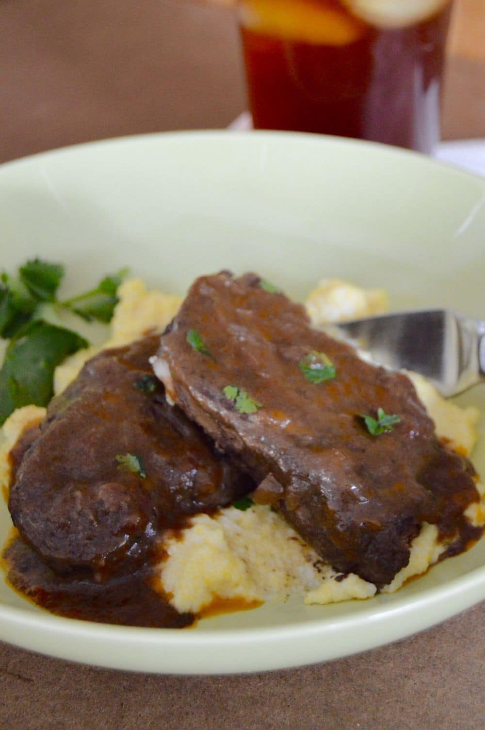 Plate of braised slow cooked short ribs over polenta