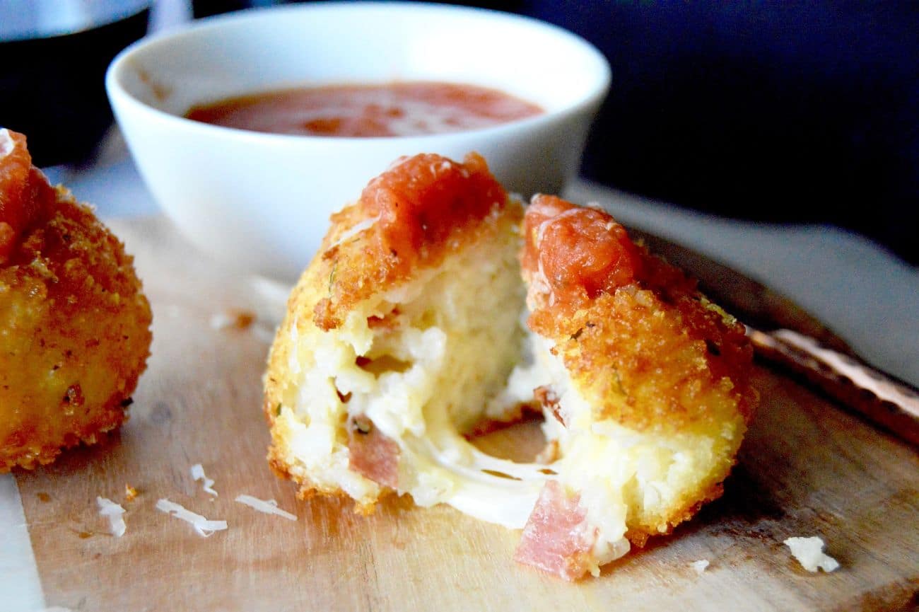 Gruyere Salami Risotto Balls (Arancini): An easy appetizer to make from leftover risotto. These Arancini balls are filled with a melty, stretchy Gruyere cheese and a spicy salami. Those are surrounded by risotto that is rolled in panko and fried for a crunchy bite of deliciousness!
