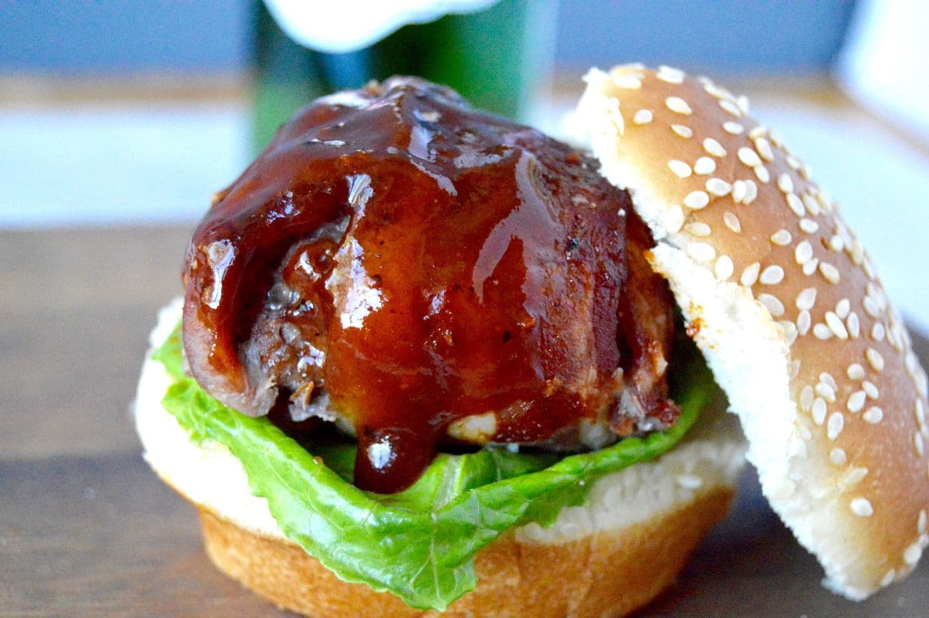 This BBQ Bacon Meatball Slider recipe is sure to be a hit! Juicy meatballs, wrapped in bacon brushed with BBQ sauce are the stars of this delicious slider!