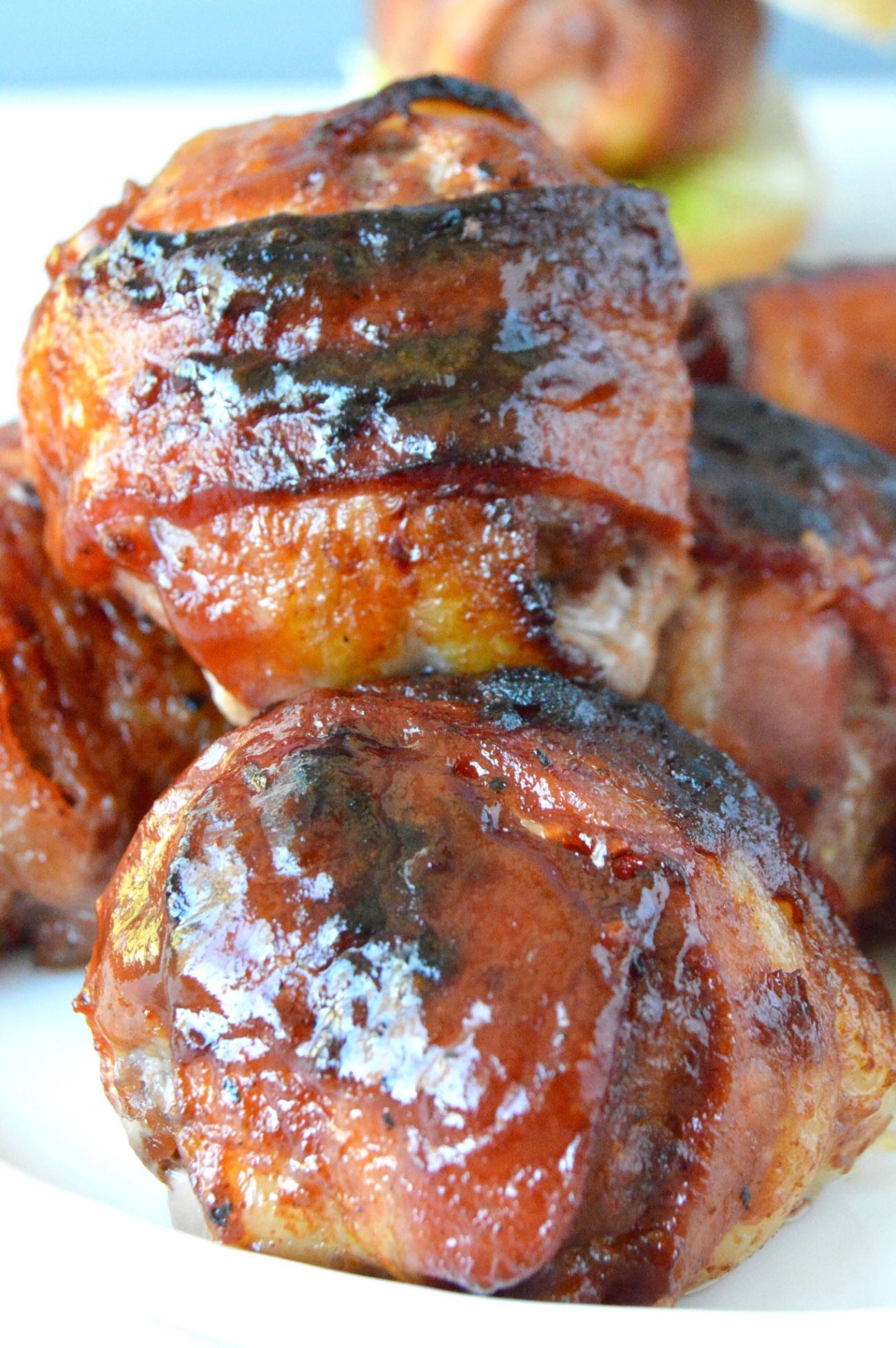 This BBQ Bacon Meatball Slider recipe is sure to he a hit! Juicy meatballs, wrapped in bacon brushed with BBQ sauce are the stars of this delicious slider!