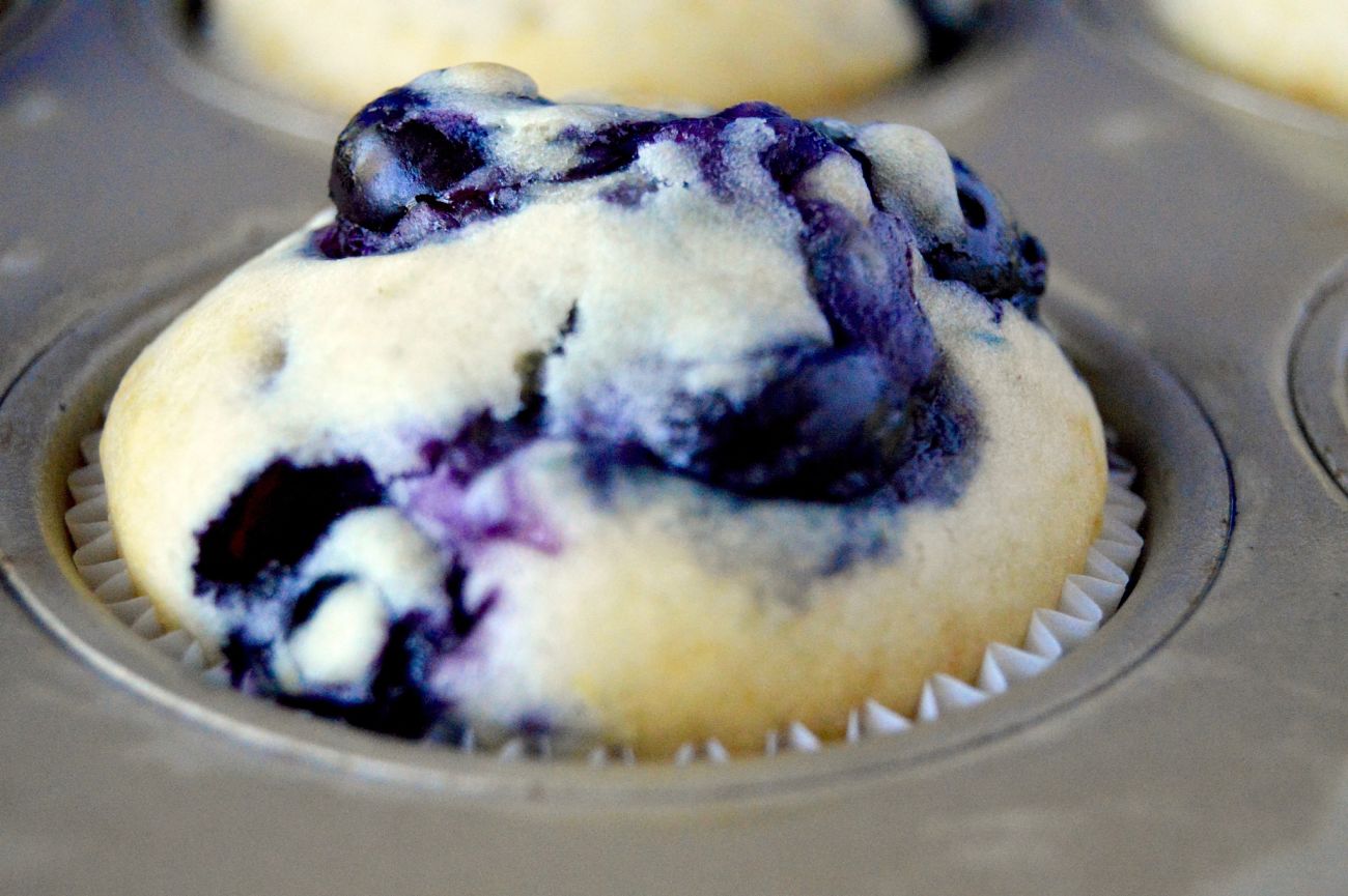 Lemon Scented Blueberry Muffins are moist on the inside, packed full of juicy blueberries in every bite. The top is crunchy and glazed with hints of lemon butter and lastly sprinkled with sugar. Perfect for taking on the go, getting together with friends or to serve at a morning meeting.