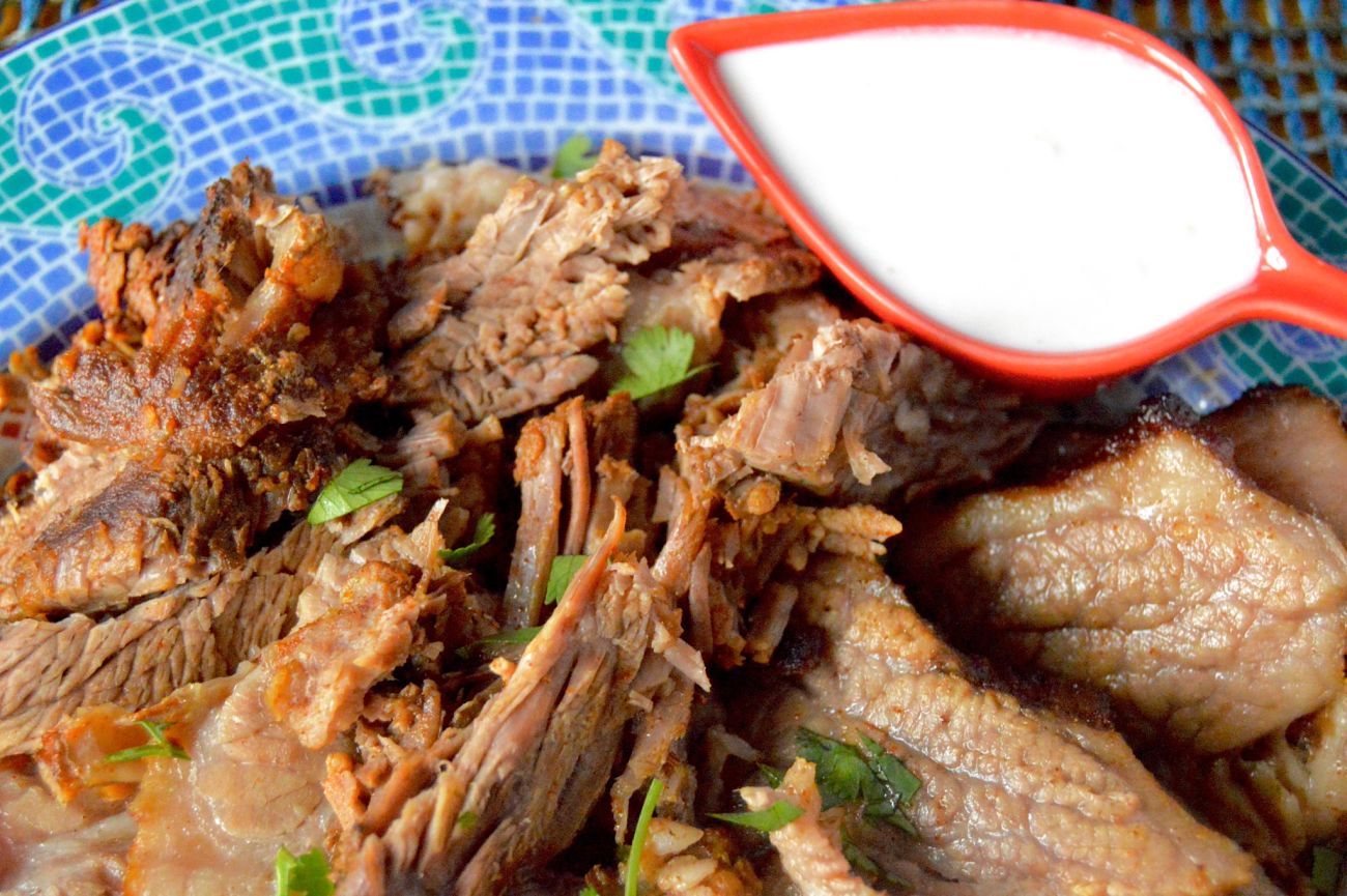 Spicy Beef Brisket with horseradish sauce on a mosaic plate