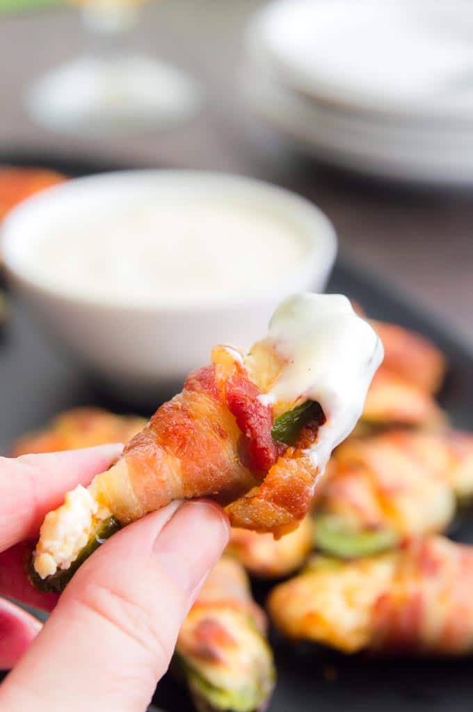 dipping the jalapeno poppers into dressing