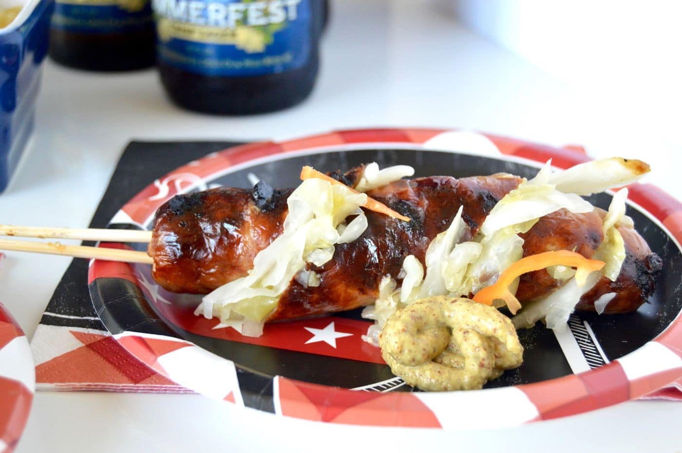 Perfect for Tailgating, these Grilled Sauerkraut Stuffed Brats on a Stick have the Kraut tucked right in! Serve then on the stick for the no carb eaters at your football game!