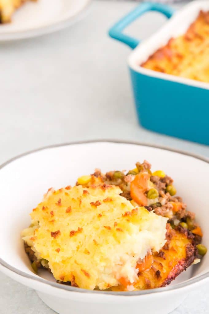 scooped serving of cottage pie in a white bowl