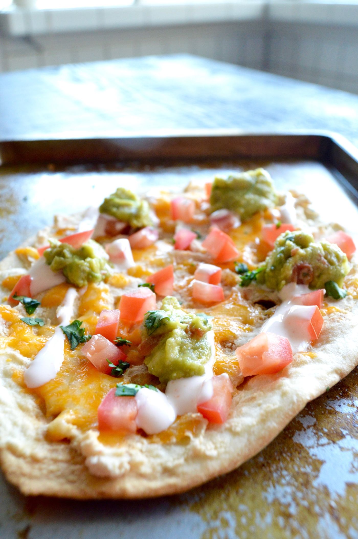 Healthy White Bean Tortilla Pizza is a great option for a lighter appetizer to have for a get together during the busy holiday season. Your guests will love all the flavors and appreciate that its a lighter option with all the heavy foods that happen during the season.