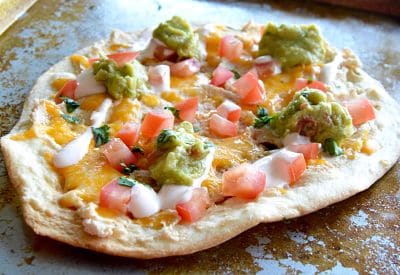 Healthy Tortilla White Bean Pizza is a great option for a lighter appetizer to have for a get together during the busy holiday season. Your guests will love all the flavors and appreciate that its a lighter option with all the heavy foods that happen during the season.