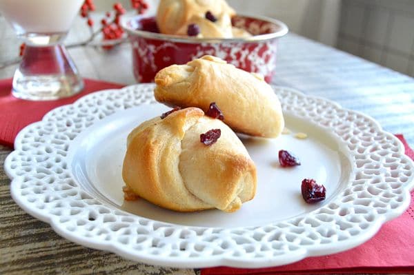 Party Brie Cheese Crescent Bites are ready in no time! Filled with Melty brie cheese, tart cranberries or nuts, baked in flaky pastry then drizzled with a bit of sweet sticky honey! These are perfect for last minute gatherings!