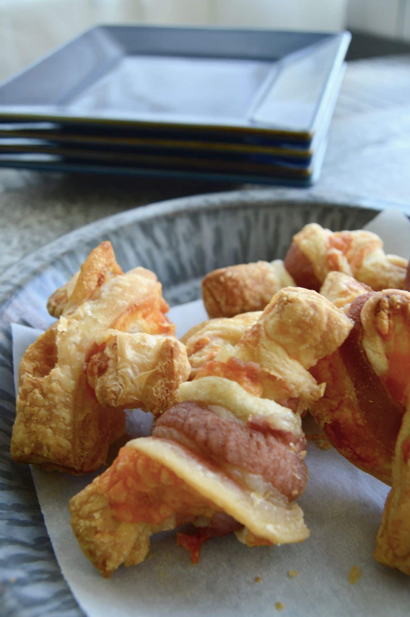 Bacon Cheese Pastry Puffs can be made quickly and with things you already have in your fridge. Cheesy in the center, wrapped with bacon each puff pastry bite is jammed full of flavor.