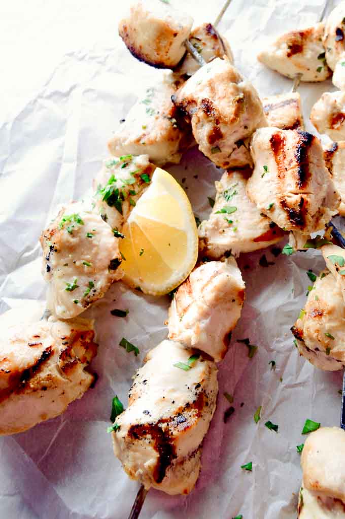 Fresh coconut lime chicken kebabs just off the bbq on a tray