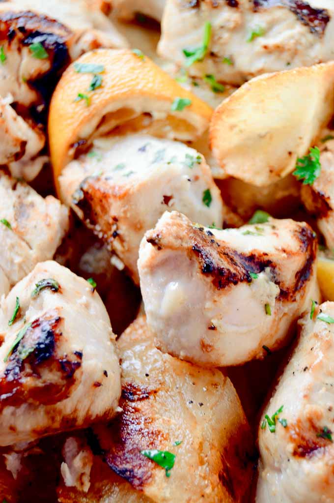 Cubes of coconut lime chicken pieces off a shish kabob