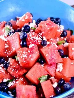 bowl of watermelon chunks with blueberries and feta