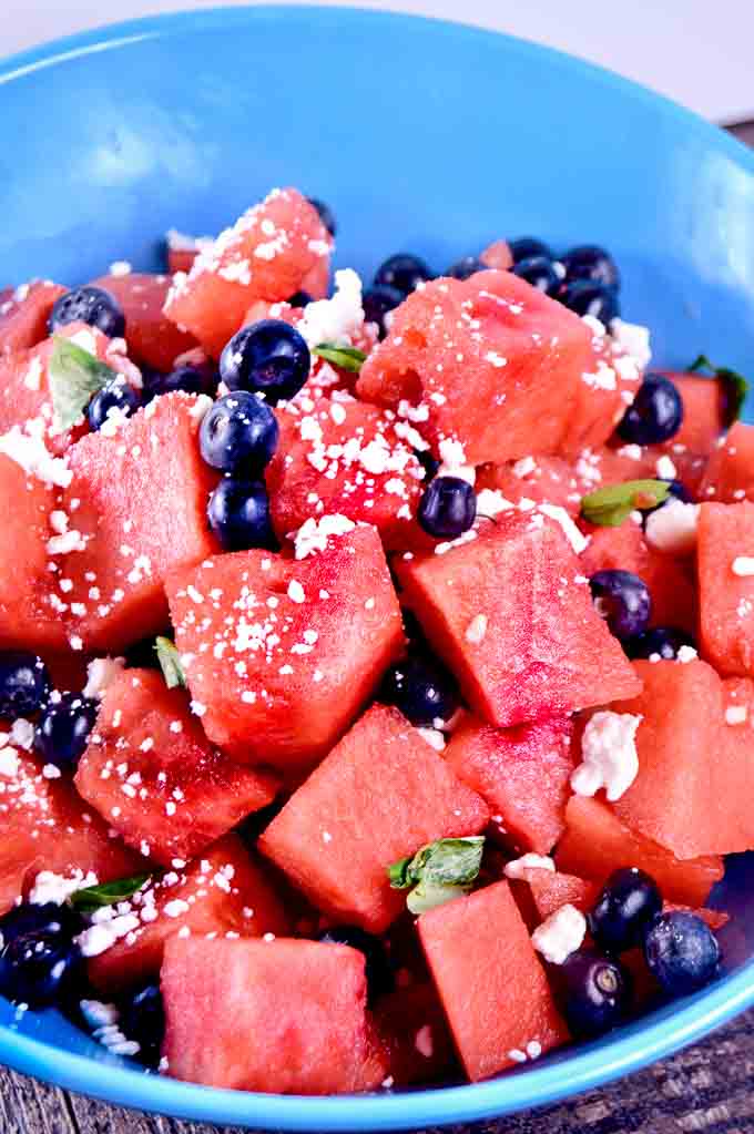bowl of watermelon chunks with blueberries and feta