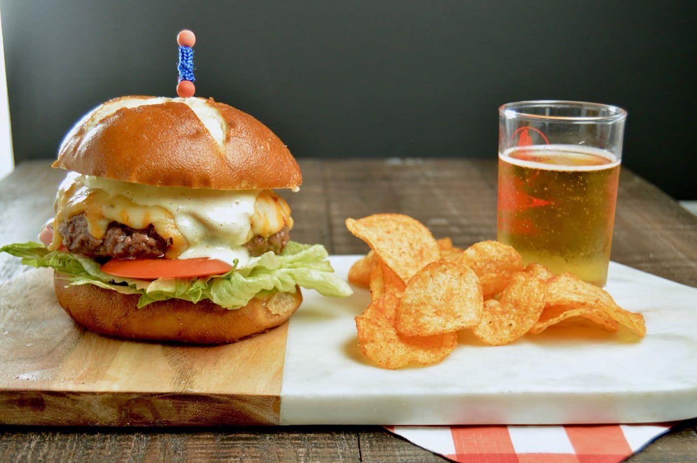 BUrger, chips and a beer on a platter