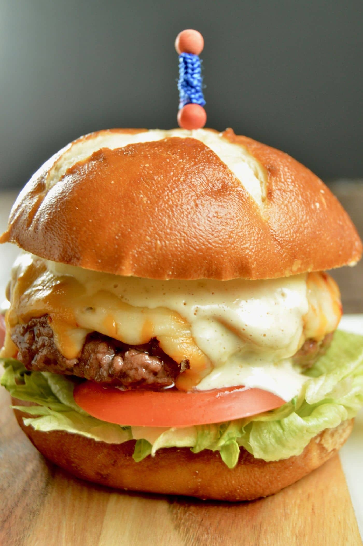 Soft bun filled with a grilled burger slathered with sauce