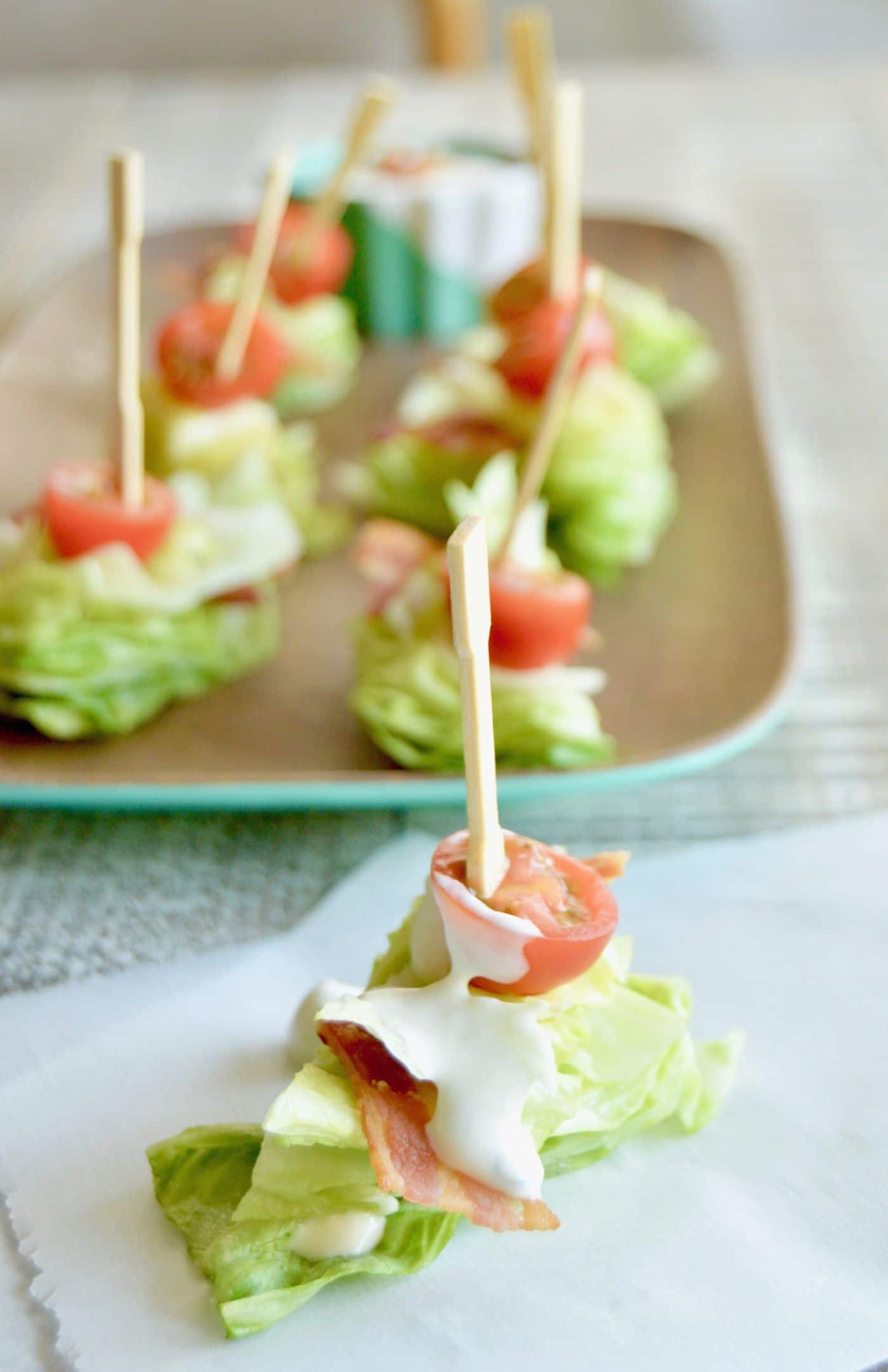 BLT's Salad Bites are a simple starter for any party. They can be made ahead and just drizzled with homemade Blue Cheese Dressing at the last minute!