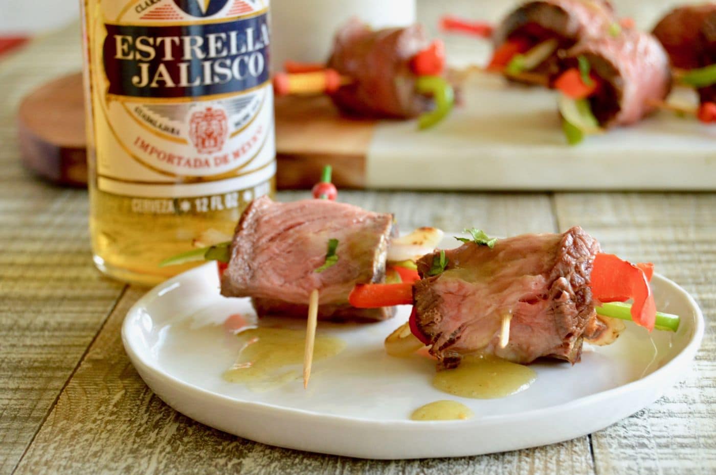 Easy Fajita Bite Appetizers are made with tender grilled steak, with softened peppers and onions all rolled into a bite sized treat.  Served with a simple salsa for maximum burst of flavor ready in less than 30 minutes for easy entertaining.