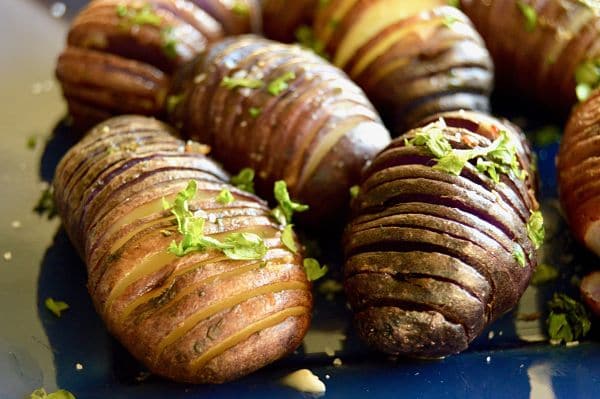 Grilled Hasselback Potatoes are ideal for entertaining. Easy to prep ahead, crunchy on the edges, lightweight centers drenched with bourbon garlic butter for lots of flavor!