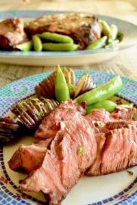 Grilled Steak with Bourbon Garlic Butter-- How to grill the perfect steak: Melted Bourbon Garlic butter blankets seared on the outside, juicy, tender on the inside steaks for an easy BBQ meal for entertaining.