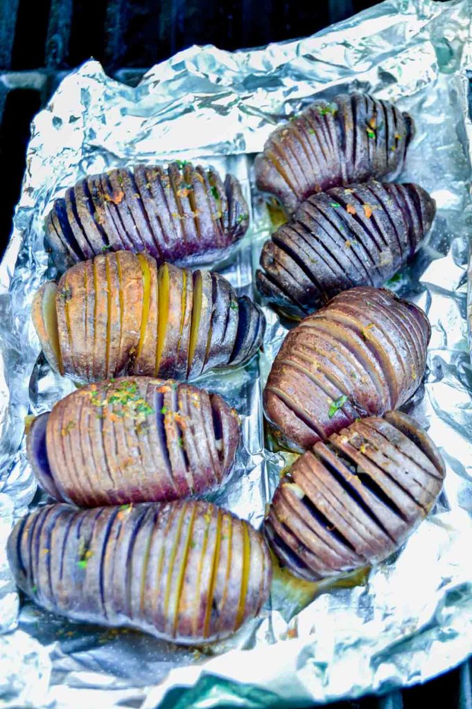 grilled potatoes on foil on a grill