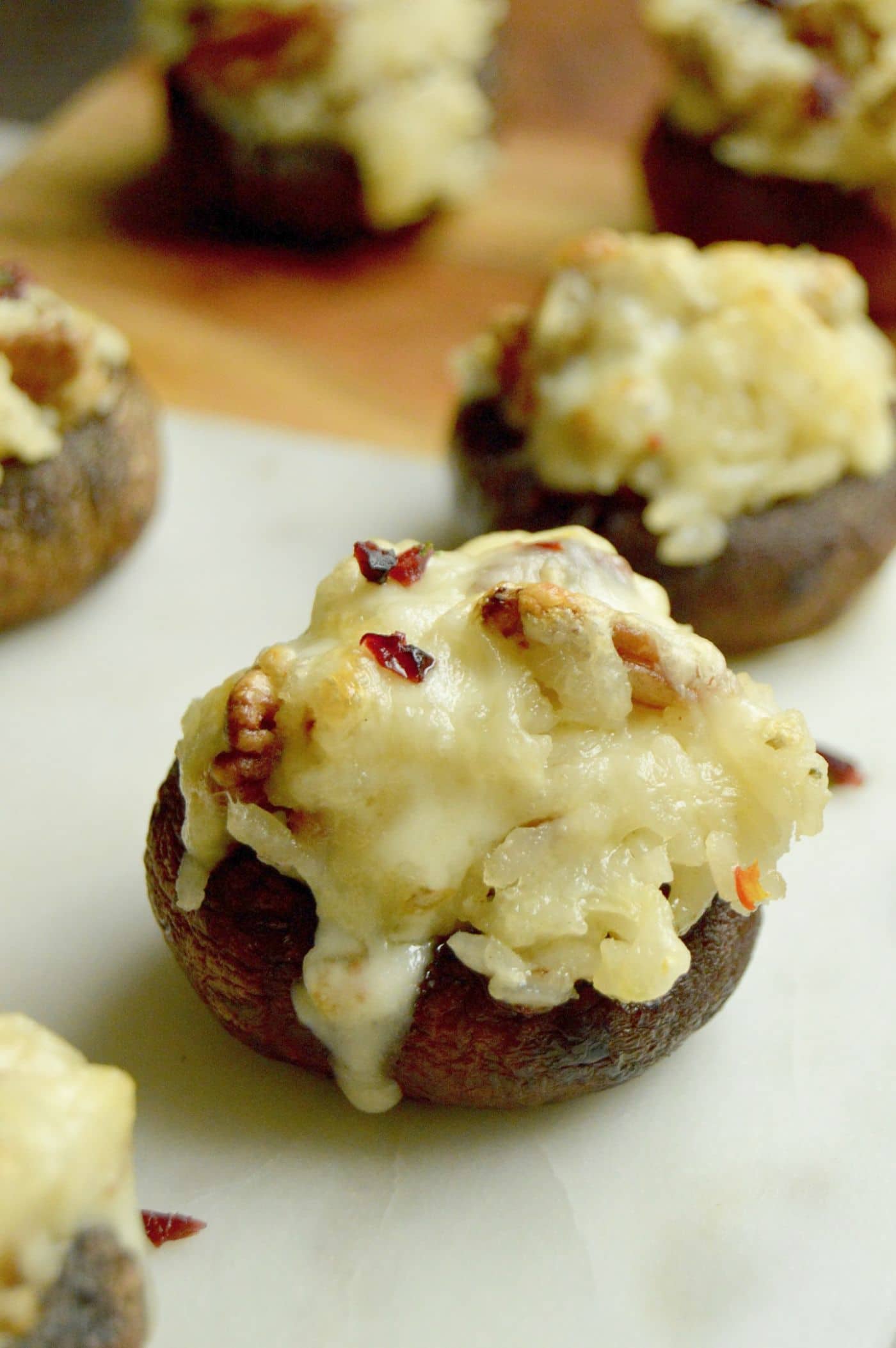 Melted cheese stirred into rice with pecans, cranberries all stuffed into tender, fresh mushrooms an appetizer your guests at any holiday party, football viewing or just for a Friday Night snack.