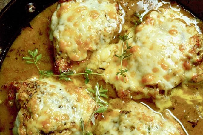 French Onion Chicken: caramelized onions under melted gooey cheese all atop braised tender chicken with a French onion style sauce.  An excellent option for dinner with friends, but your family will want it for a weeknight dinner option!