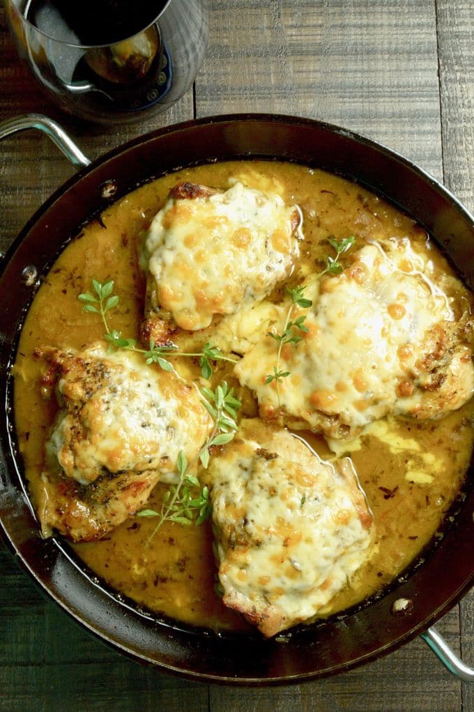 French Onion Chicken: caramelized onions under melted gooey cheese all atop braised tender chicken with a French onion style sauce.  An excellent option for dinner with friends, but your family will want it for a weeknight dinner option!