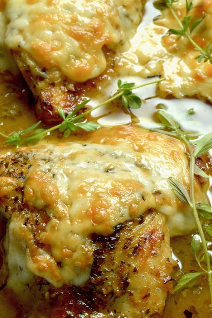 French Onion Chicken: caramelized onions under melted gooey cheese all atop braised tender chicken with a French onion style sauce.  An excellent option for dinner with friends, but your family will want it for a weeknight dinner option!