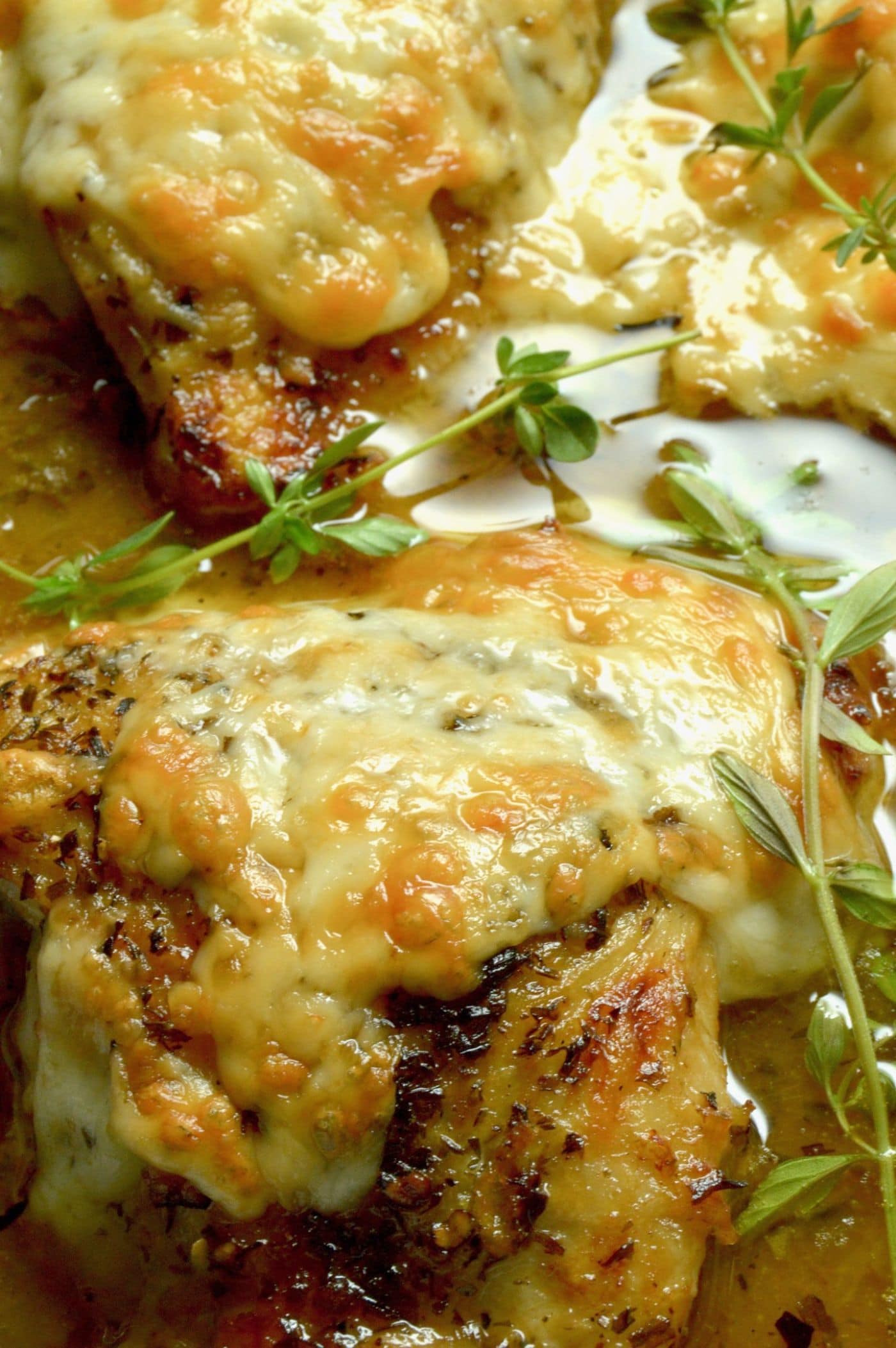 French Onion Chicken: caramelized onions under melted gooey cheese all atop braised tender chicken with a French onion style sauce.  An excellent option for dinner with friends, but your family will want it for a weeknight dinner option!