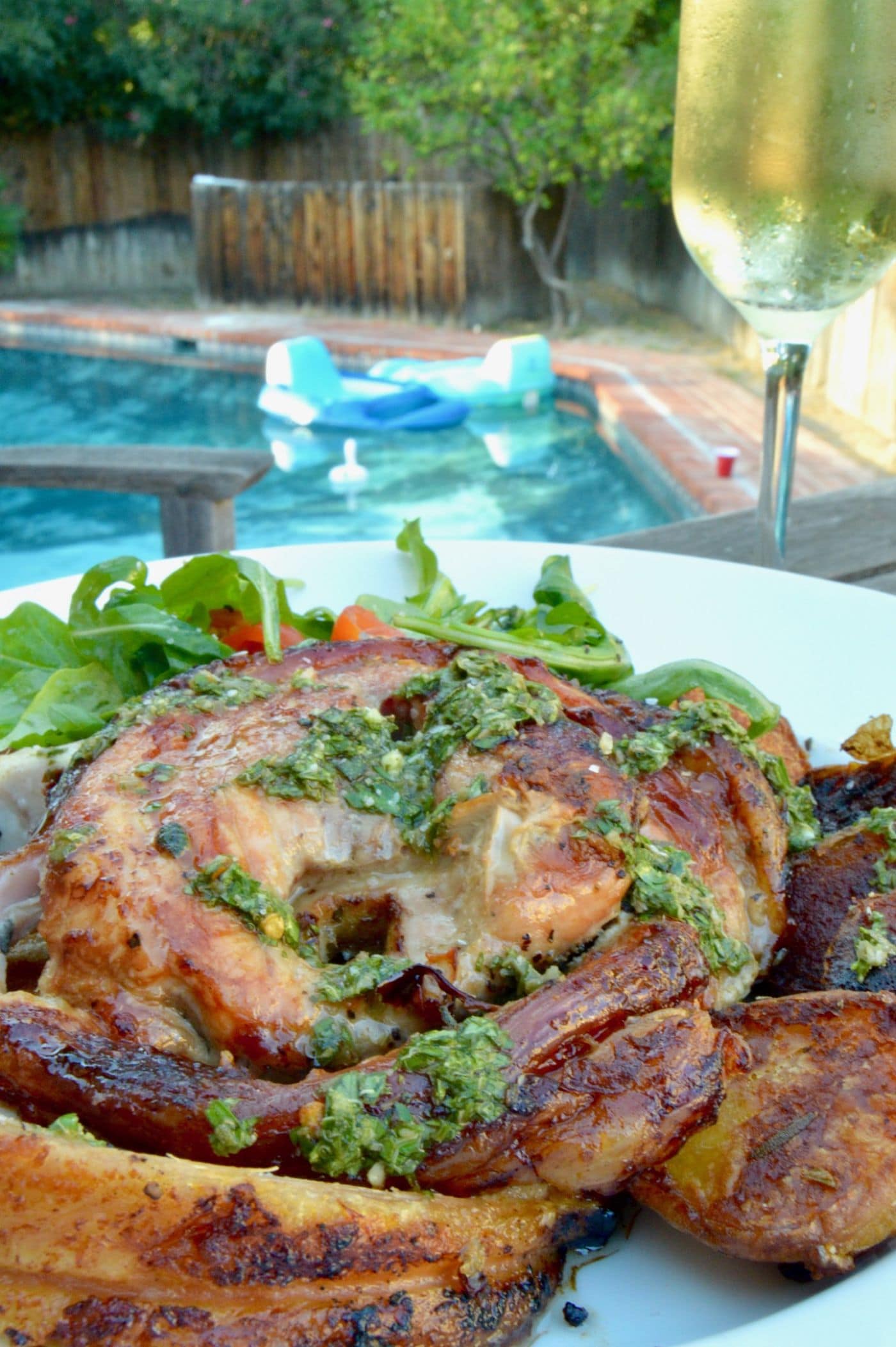 Pool side dining showcasing Porchetta, Crispy Pork Belly with herbs wrapped around a pork tenderloin and cooked to juicy, tender perfection.  A crazy impressive meal to your guests, but you'll know how simple it was to make!Porchetta, Crispy Pork Belly with herbs wrapped around a pork tenderloin and cooked to juicy, tender perfection.  A crazy impressive meal to your guests, but you'll know how simple it was to make!
