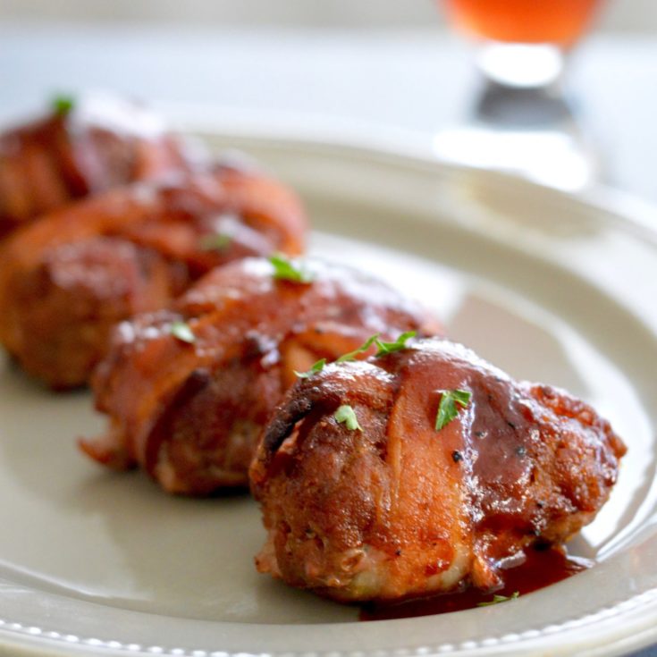 Hearty bacon Meatloaf Appetizer Bundles:... shown being served on a platter for holiday entertaining.