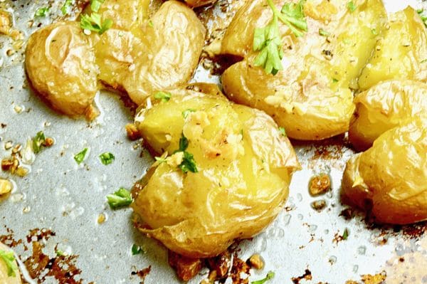 Smashed Lemon Garlic potatoes crusty crunchy on the outside, creamy inside bursting with fresh herb flavors.  A show stopping potato side dish for entertaining! Westviamidwest.com #sidedish #potatoes