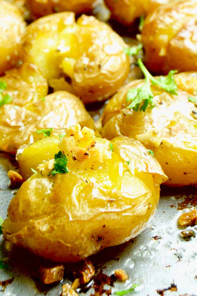 smashed potatoe with crunchy garlic on a tray