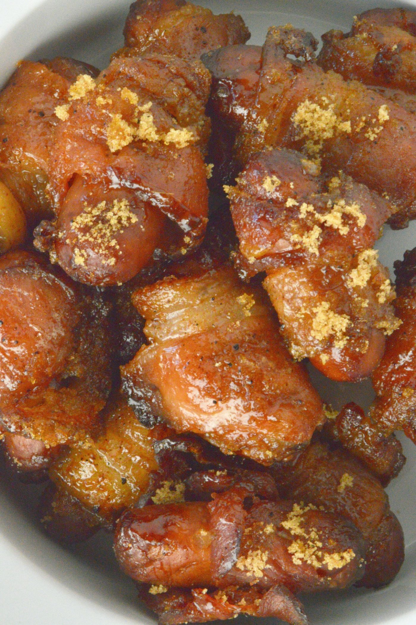 Bowl of smokies Spicy Sugar Bacon Smokies!!  Crispy Bacon wrapped smokies are a bite sized treat that have a brown sugar coat that has a hint of spiciness!  Perfect for game-day snacks or any casual cocktail party.