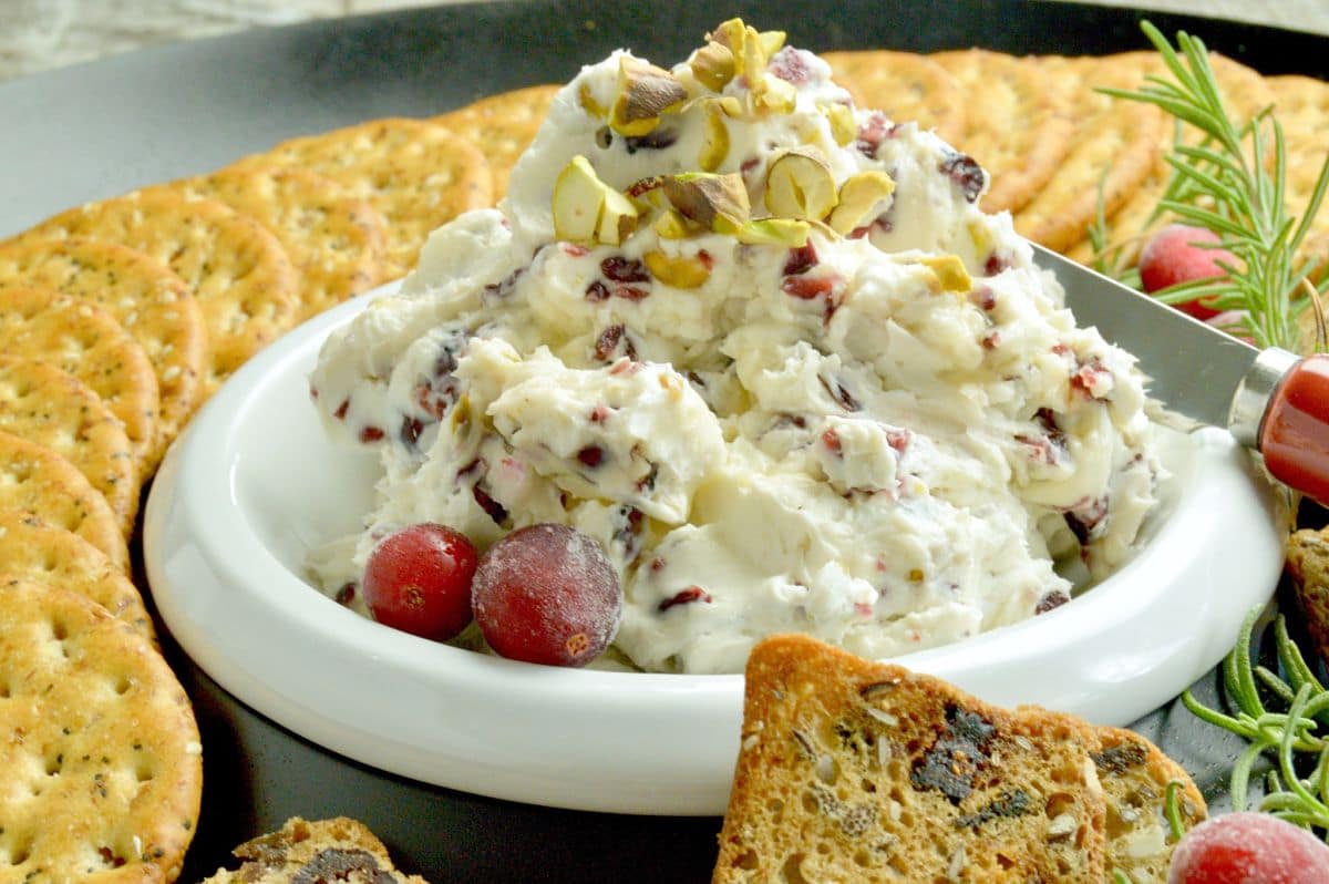 Full of tangy cream cheese accented with tart orange, sweet cranberries this festive Cranberry Orange Cream Cheese Dip for Crackers is perfect for all of your holiday parties, from happy hour to watching the big games!  