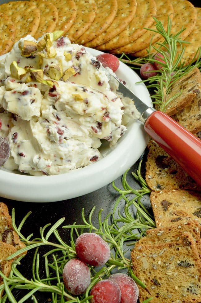 Full of tangy cream cheese accented with tart orange, sweet cranberries this festive Cranberry Orange Cream Cheese Dip for Crackers is perfect for all of your holiday parties, from happy hour to watching the big games!  