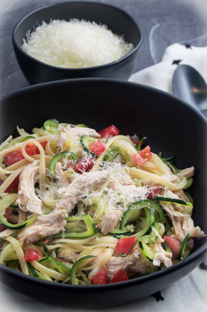 Bruschetta Chicken Breast in a bowl with zucchini pasta noodles with parmesan cheese