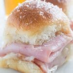 Easy Ham and Swiss Sliders on Hawaiian rolls are the perfect finger food for game day parties.  10 min prep and then just pop in the oven 20 minutes before you are ready to serve!  
