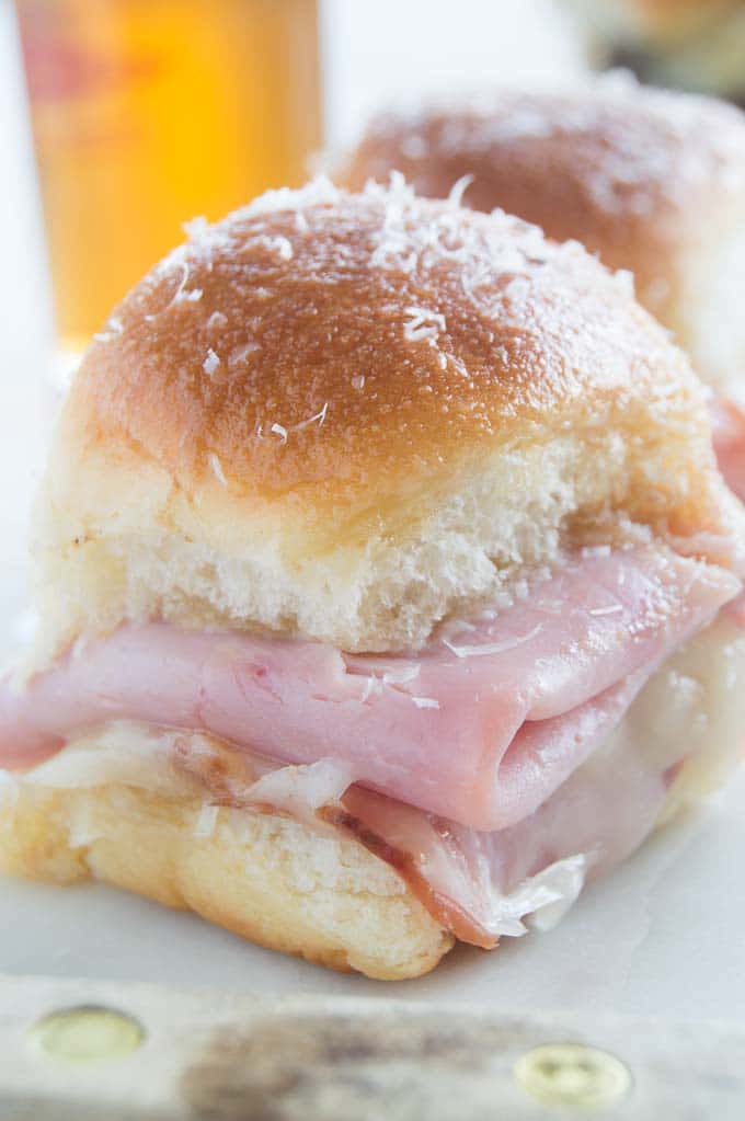 Easy Ham and Swiss Sliders on Hawaiian rolls are the perfect finger food for game day parties.  10 min prep and then just pop in the oven 20 minutes before you are ready to serve!  