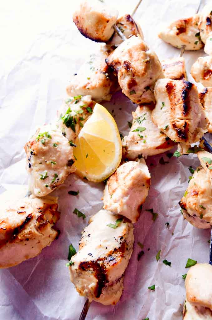 Grilled Coconut Lime Chicken Skewers just off the grill on parchment paper