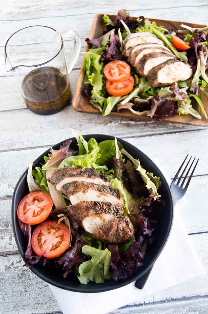 Grilled Jerk Chicken Breast sliced over salad on your picnic table!
