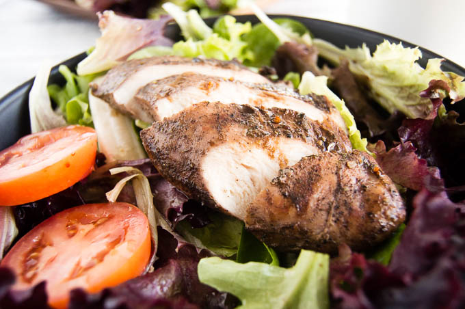 Grilled Jerk Chicken Salad with thick slices of jerk seasoned chicken breast.