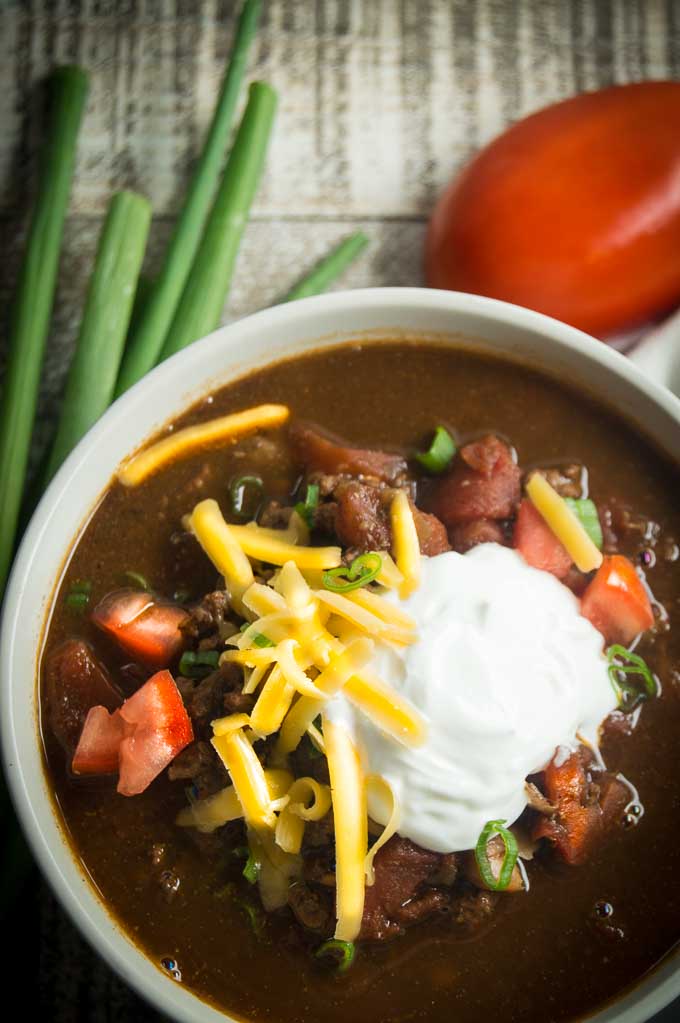 bowl of chili with toppings on it