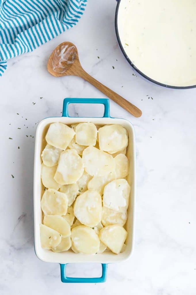 Par boiled sliced potatoes in a baking dish