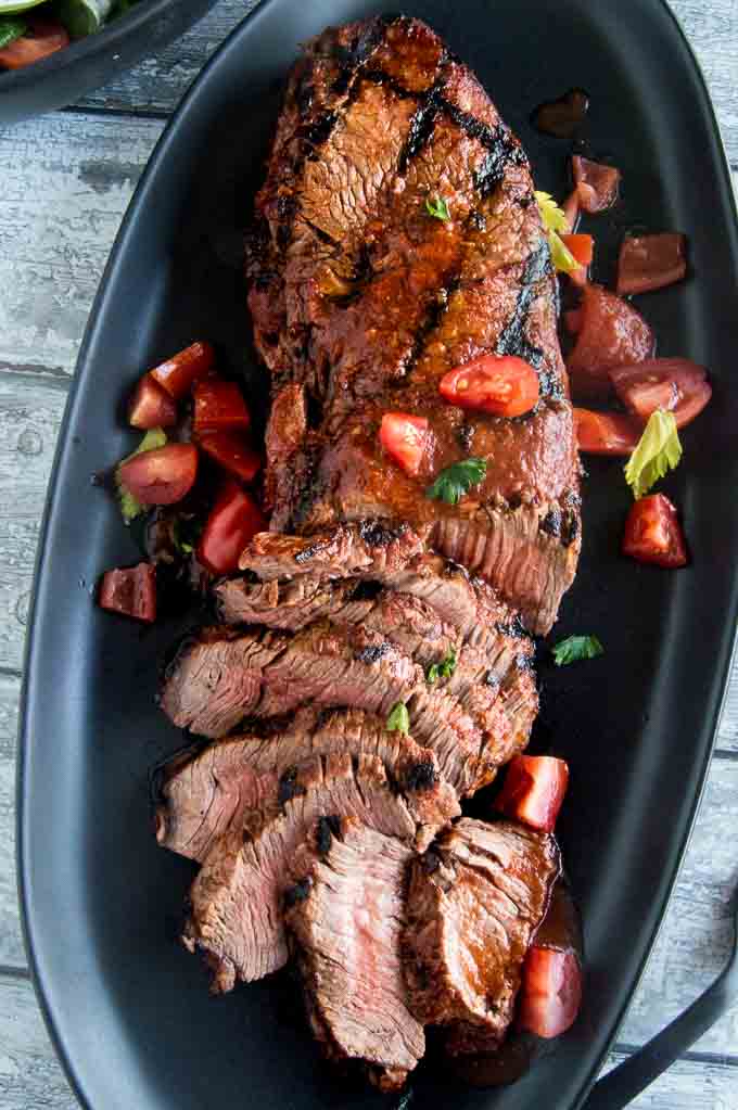 Flank steak marinated and sliced across the grain for ultimate tenderness