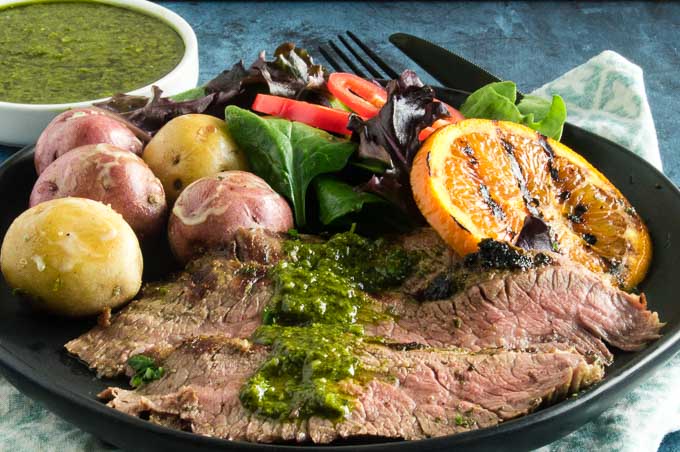 Grilled Chimichurri Steak, an authentic Argentinian recipe which uses a 5 minute simple sauce-marinade from made of fresh herbs, garlic, lemon juice and olive oil.  Marinate for concentrated flavor or brush on as its grilling!