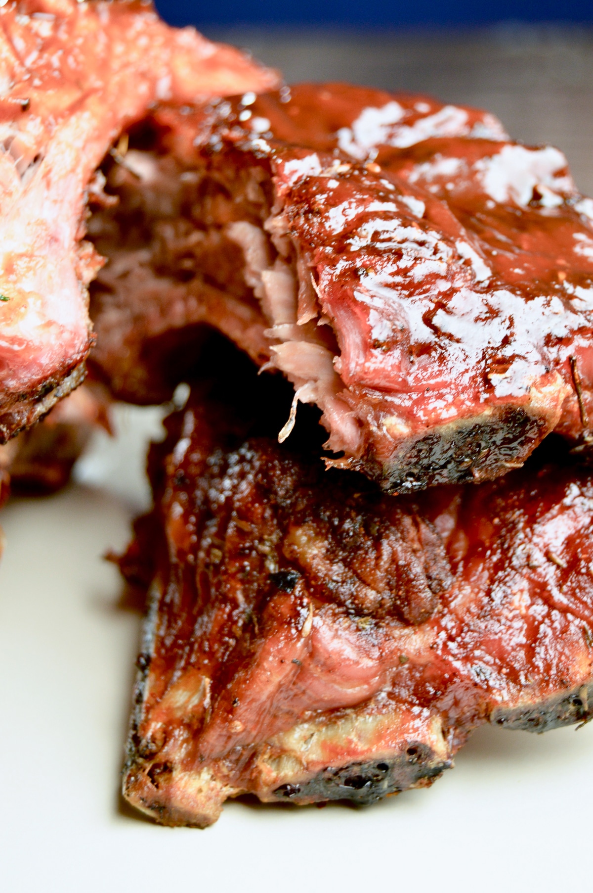 two large baby back ribs on a plate